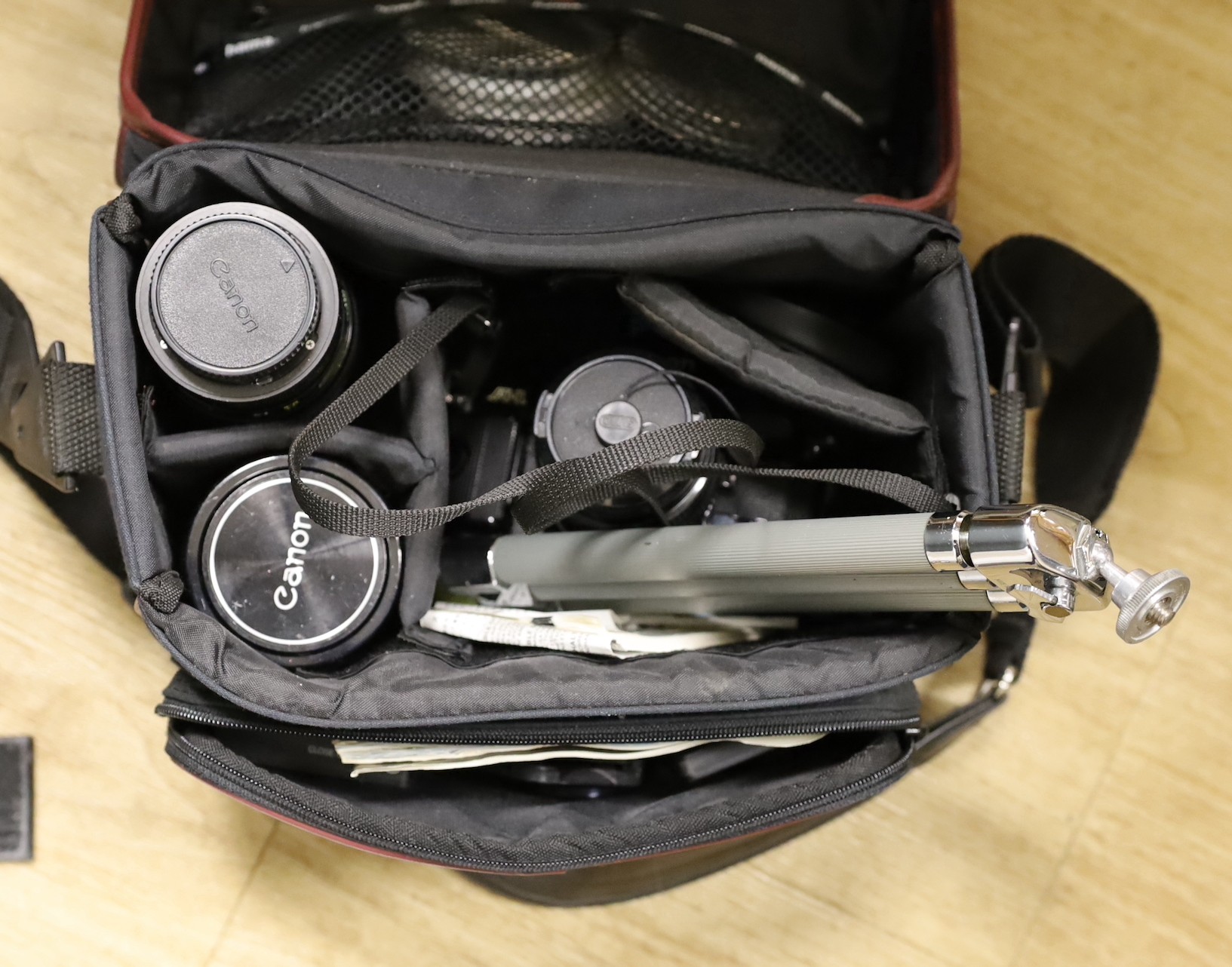 A Canon EF 35mm SLR camera with a 50mm 1:1.4 lens, together with a Susis rapid tripod stand and two other lenses